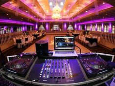 a laptop computer sitting on top of a dj's desk