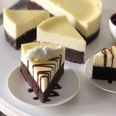 several slices of cheesecake on plates with chocolate sauce