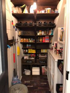 an open pantry with lots of food on the shelves and other items in the room