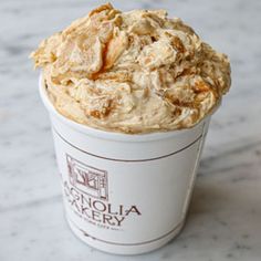 a close up of a cup of food on a table with a marble counter top