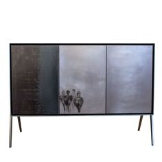 a black and silver cabinet with three pictures on it