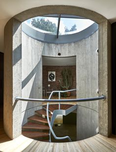 the inside of a house with stairs leading up to an open door and skylight