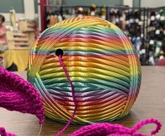 a ball of yarn sitting on top of a wooden table