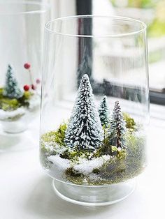 two glass vases filled with snow covered trees