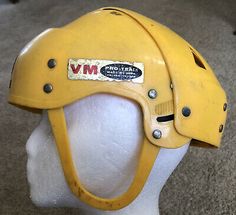 a yellow helmet on top of a white mannequin head