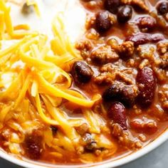 chili with cheese and beans in a white bowl