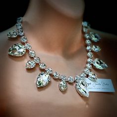 a close up of a necklace on a mannequin's neck with diamonds