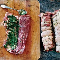 raw meat on cutting board next to serving utensils with pesto and seasoning