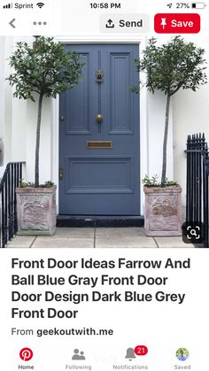 the front door is painted blue and has two planters with trees in them on either side