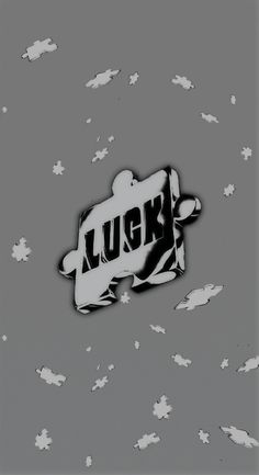 the word luck is written in black and white on a gray background with small clouds