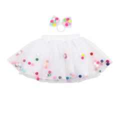 a white skirt with multicolored polka dots on the bottom and tulle underneath