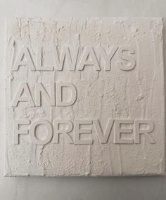 a white sculpture with words on it that says, always and foreverer in the center