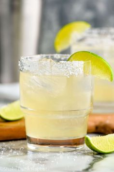 two margaritas with lime and sugar on the rim