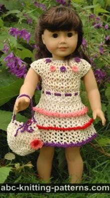 the doll is wearing a crocheted dress and holding a purse in her hand