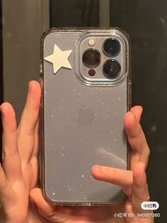 someone is holding up their phone case with a star on the front and back side