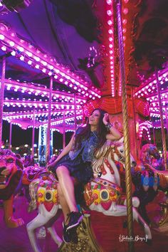 a woman sitting on top of a merry go round