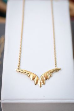 14k Gold Vermeil over sterling silver wings handcrafted by a husband and wife team in New Orleans. Vermeil refers to the thickness of gold plated over sterling silver. The layer of gold is at least 2.5 microns thick. Vermeil is far more durable than other plated options. Elegant Winged Gold Jewelry, Gold Winged Necklace Perfect As A Gift, Gold Winged Sterling Silver Jewelry, Elegant Gold Winged Jewelry, Gold Winged Necklace For Gift, Elegant Wing-shaped Gold Jewelry, Elegant Gold Wing-shaped Jewelry, Elegant 14k Gold Wing-shaped Jewelry, Elegant Gold Necklace With Angel Wings