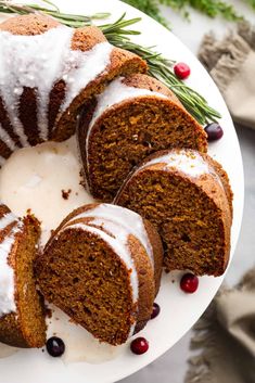 a bundt cake with icing and cranberries on a plate