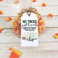 a bag filled with candy corn sitting on top of a wooden table