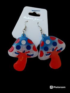 These are red white and blue  mushroom earrings they are detailed with matching red white blue acrylic paint then clear coated to seal the pretti3s forever ❤️🤍💙 we also do custom creations just message me anytime for more information😊 Fun Red Resin Earrings, Fun Style Red Resin Earrings, Handmade Blue Patriotic Earrings, Patriotic Blue Earrings For Gift, Blue Mushroom, Mushroom Earrings, Red White And Blue, Red White Blue, Custom Creations