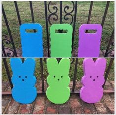 four different colored plastic bunny bags sitting on top of each other in front of a gate