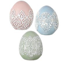 three different colored eggs with lace designs on them