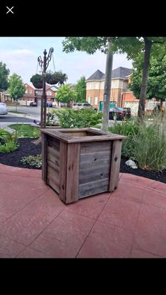 a wooden box sitting on top of a sidewalk