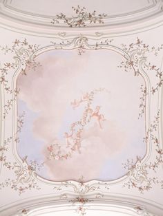 the ceiling is painted in pink and white