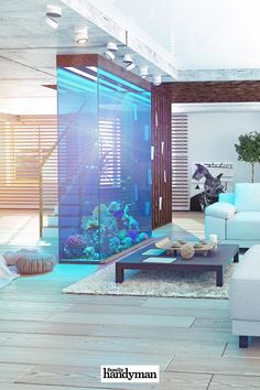 a living room filled with furniture and a fish tank in the middle of the room