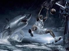 a man jumping into the air to dunk a basketball in front of a shark