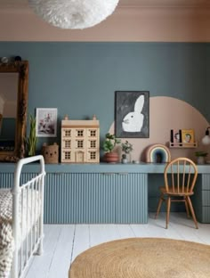 a baby's room with blue walls and white floors