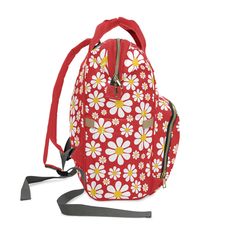 a red backpack with white and yellow flowers on it