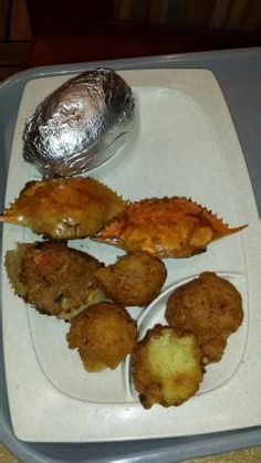 a tray with some food on it and a tin foil wrapper over the top