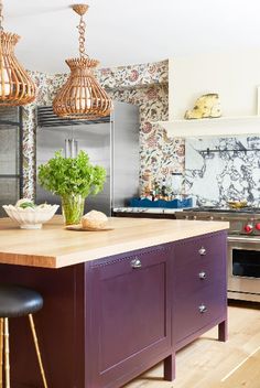 a kitchen with purple cabinets and wooden counter tops