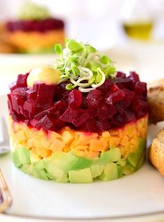 a colorful dessert sits on a white plate