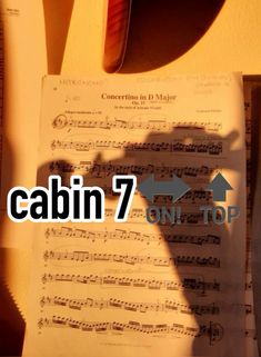 the shadow of a person's hand on top of sheet music with words that read cabin 7