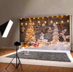 a christmas scene with lights and decorations on the wall in front of a wooden background