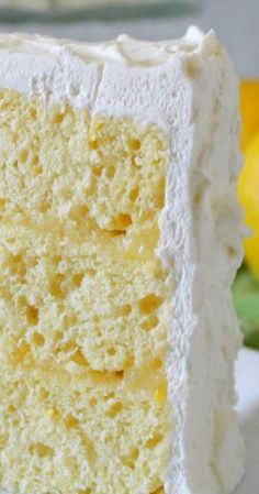 a close up of a slice of cake on a plate with flowers in the background