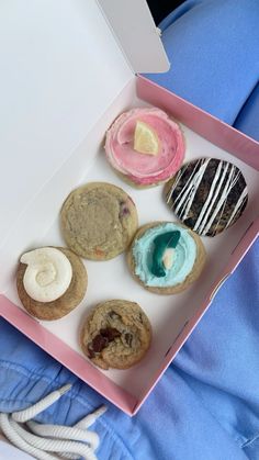 a pink box filled with different types of donuts