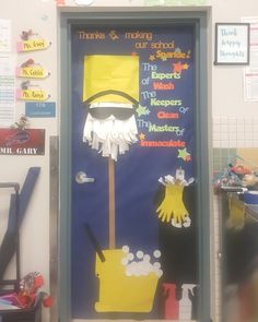 a door decorated to look like a broom and bucket with cleaning supplies on it in front of a classroom wall