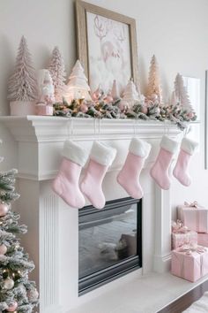 christmas stockings hanging from the mantel in front of a fireplace decorated with pink and white ornaments