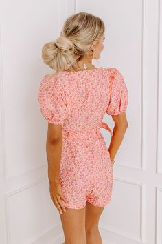 - Blossoming beauty has arrived with this darling floral jacquard romper! With delicate blooms, its puff sleeves add a touch of whimsy while the flattering belted waistline accentuates your curves with a sprinkle of charm. Perfect for picnics in the park or strolls through sun-kissed gardens, this romper radiates sweetness and bubbly flair, making every moment feel like a delightful adventure in full bloom. - Unlined floral jacquard material featuring pink and orange hues - A square cut neckline Orange Hues, Picnic In The Park, Floral Jacquard, In Full Bloom, Square Cut, Sun Kissed, Puff Sleeves, The Park, Pink And Orange