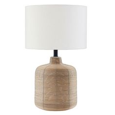 a table lamp with a white shade on the base and a light bulb in the middle