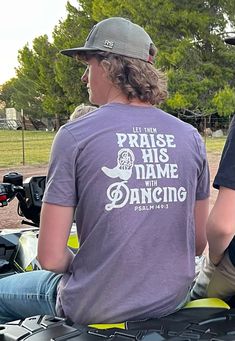 Let them paise His name with dancing. Pslams 149:3 We love to dance and lift our spirits wearing our buttery soft t-shirts. Offered in 2 colors: Heather Purple and Heather Sage  50% Polyester/25% Cotton/25% Rayon Thank you for supporting the Buckshot Boys!  Check us out on TikTok, Instagram, and YouTube. Casual T-shirt With Letter Print For Dance Class, Casual Crew Neck T-shirt For Dance Class, Casual Letter Print T-shirt For Dance Class, Casual Graphic Print T-shirt For Dance Class, Casual T-shirt With Text Print For Dance Class, Casual Text Print T-shirt For Dance Class, Casual Cotton T-shirt For Dance Class, Casual Text Print Top For Dance Class, Heather Purple