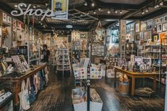 the inside of a store with lots of pictures on the walls and wooden flooring