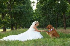 the bride and her dog are sitting in the grass