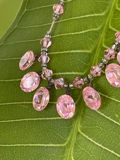 This is a delicate sparkling art deco necklace with pink faceted stones. The wire work is very good and detailed. There are 7 main stones that hang beautifully and symmetrically. It is just under 16 inches including loop clasp. There are 22 clear light pink rondelles that grace the length of the necklace. The stones are connected only at the top of each bead by wire, which allows each stone to hang independently. This is a short length necklace so be sure to check measurement. Length Necklace, Crystal Necklaces, Art Deco Necklace, Wire Work, Pink Glass, Pale Pink, Crystal Necklace, Labour Day, Light Pink