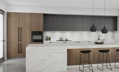 a modern kitchen with marble counter tops and wooden cabinets, along with bar stools