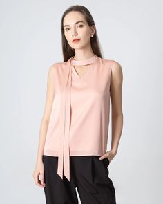 Type: Women's Tie Neck Blouse. Material: 19 Momme Luxury Mulberry Silk. Features: Satin, wear-resistant and stylish. Details: Classic Solid Color, Designed Sleeveless&Tie Neck, Regular Fit. Introducing our sleeveless silk blouse for women—a versatile essential that effortlessly transitions from formal to casual. Crafted from luxurious silk fabric, the top features a v neckline and a front tie for customizable styling. Whether you prefer a classic knot or a playful bow, this v-neck silk top is pe