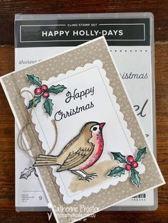 two christmas cards sitting on top of a wooden table next to each other, with the words happy holly - days written on them